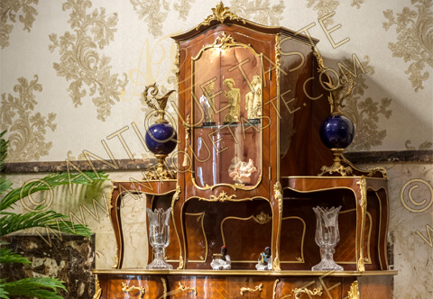 A stunning Louis XV style ormolu-mounted veneer inlaid and parquetry Two Tier Royal Console De Desserte and Vitrine Cabinet after the model by Francois Linke upholstered with tufted velvet and adorned with ormolu Rococo elements and foliate ormolu filet to the contour; with three central drawers and bombe glass door and lower shelf connecting the cabriole legs